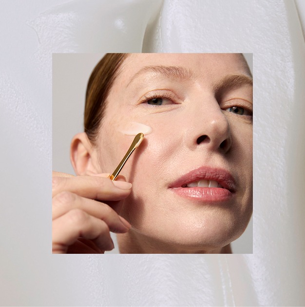 A model applying Tatcha's healthy-aging skincare products with a gold spoon