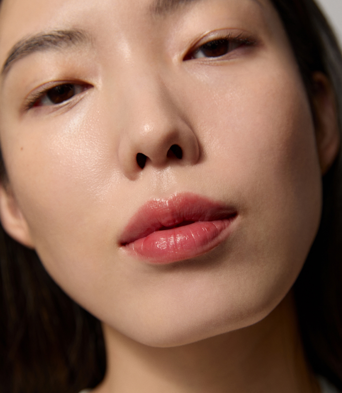 An image of a model wearing the new Kissu Lip Mask in a deep red shade