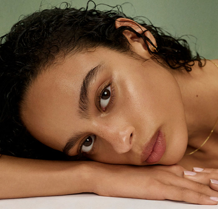 An image of a model showing the finish of Tatcha's new cleanser, The Matcha Foam Cleanse