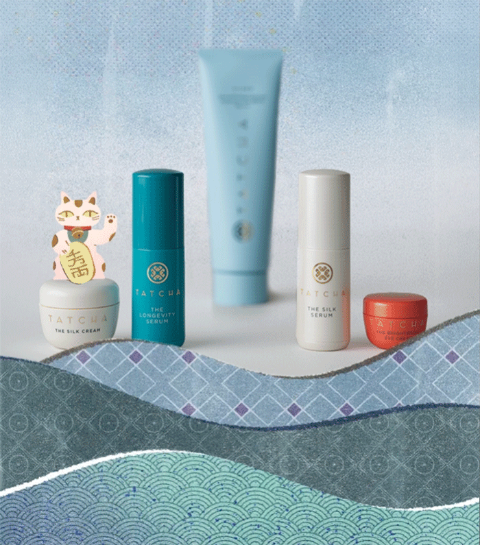 An image of a selection of Tatcha products with an animated cat and fish jumping out of water.