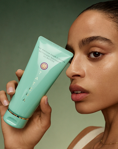 An image of a model holding The Matcha Foam Cleanse