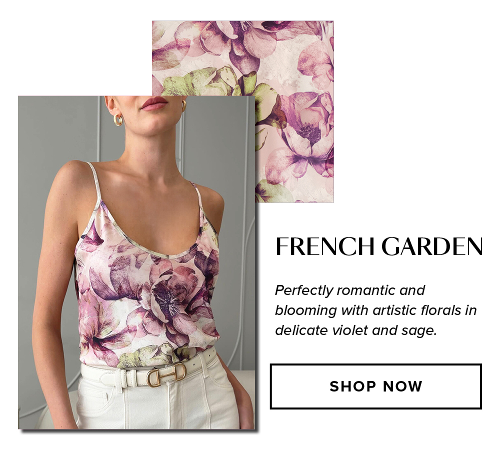 French Garden. Perfectly romantic and blooming with artistic florals in delicate violet and sage. An image of a model wearing the Yara Silk Camisole in French Garden in a minimal modern room.