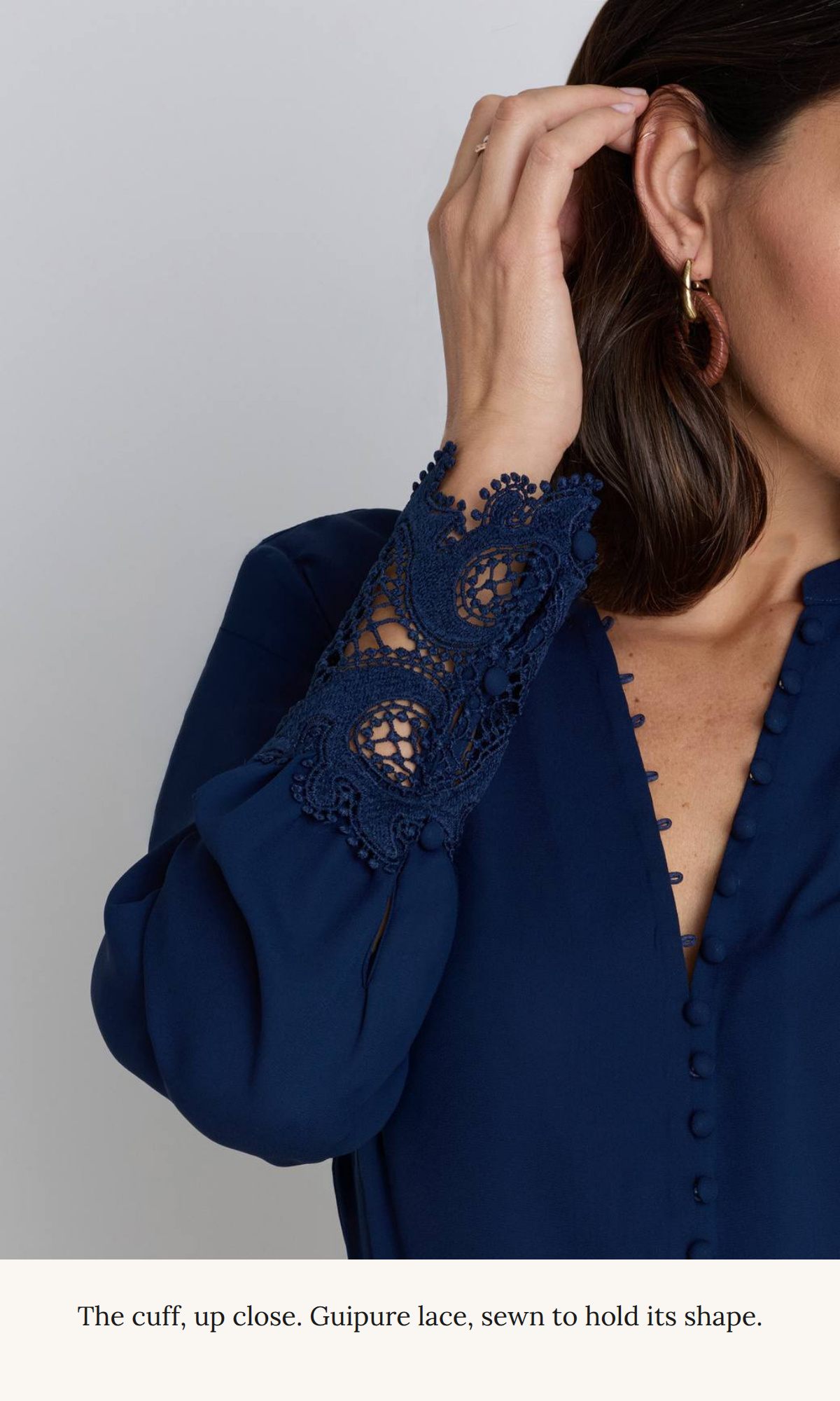 Close-up of the navy guipure lace cuff on the Blake blouse, sewn to hold its shape.