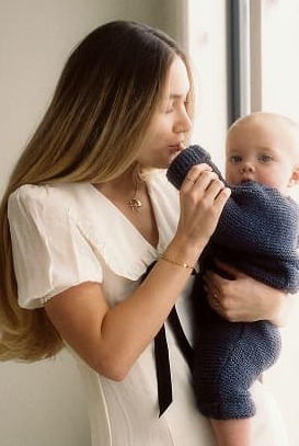 Keepsake jewelry on a young mom holding her baby