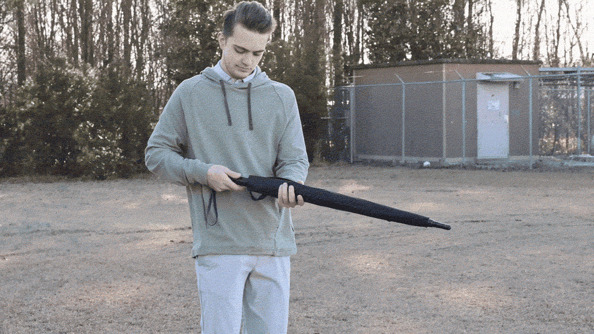 woman standing outside holding an umbrella