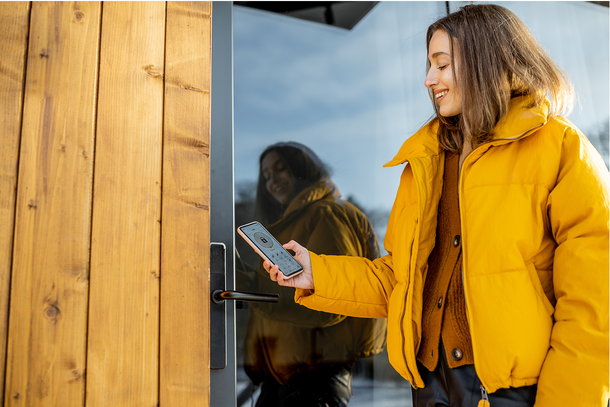 Woman using phone to lock the door