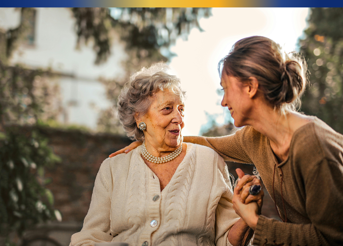 woman sitting with her mother outside
