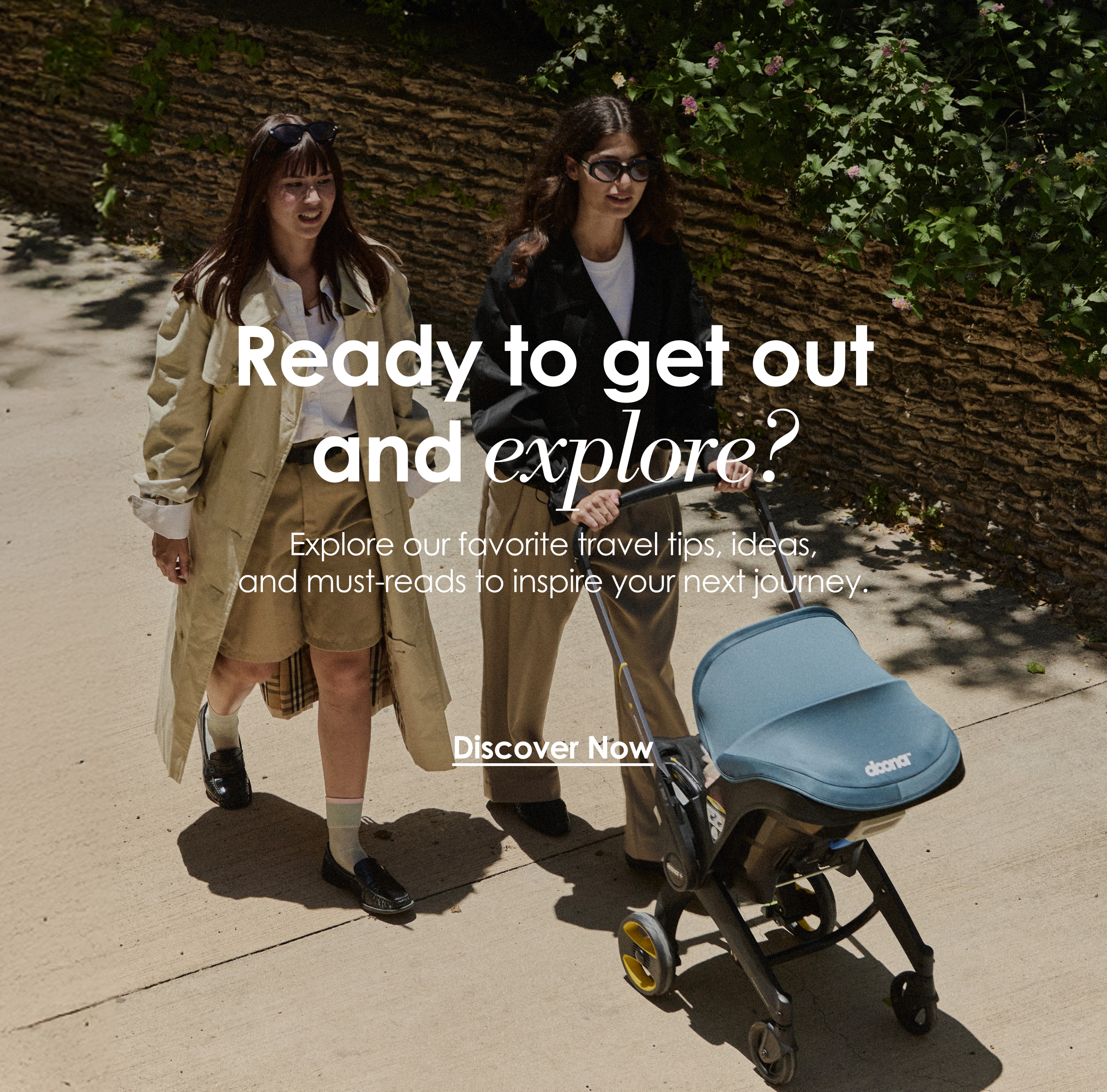 Woman pushing a Doona Car Seat & Stroller outdoors with another woman walking beside her.