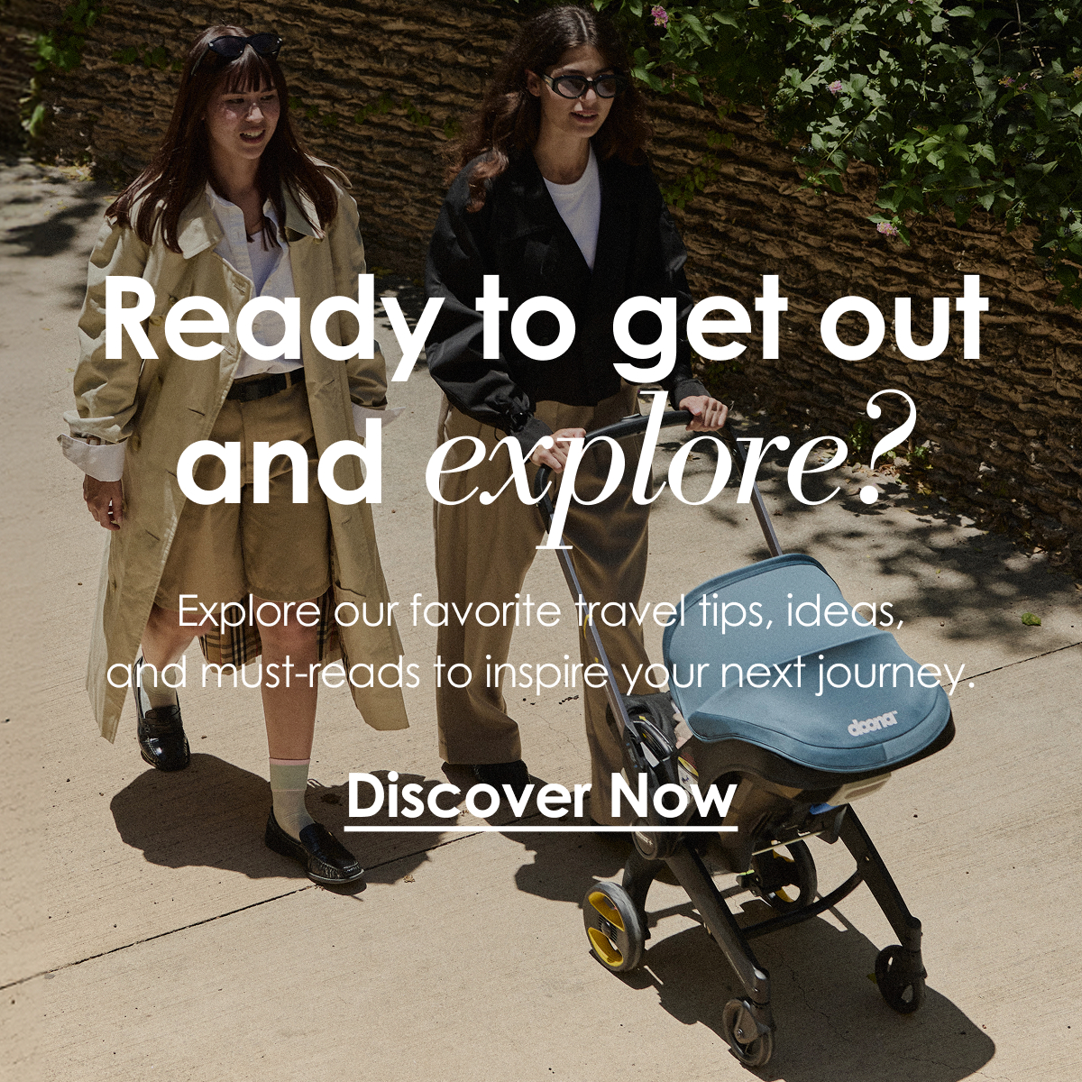 Woman pushing a Doona Car Seat & Stroller outdoors with another woman walking beside her.