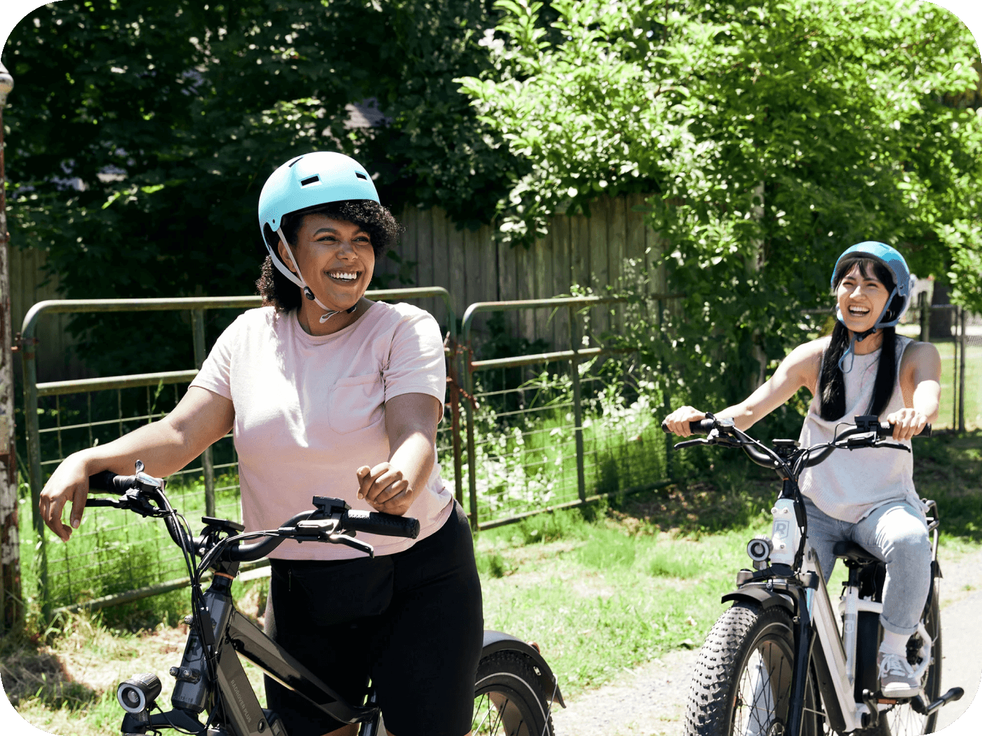 Two people riding ebikes outdoors