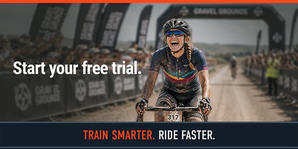 Cyclist crosses finish line under archway, with text "Start your free trial."