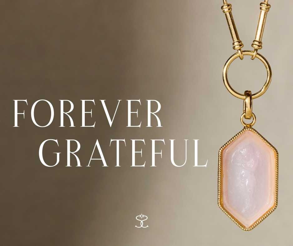 A photo of a charm necklace featuring a small angel with "new for mother's day"