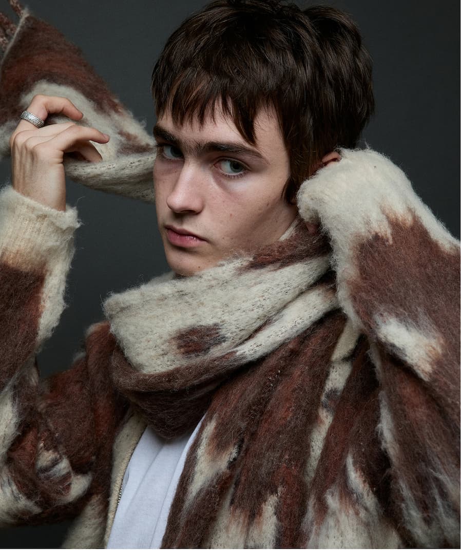 A model wearing a zipper Obey jumper for men