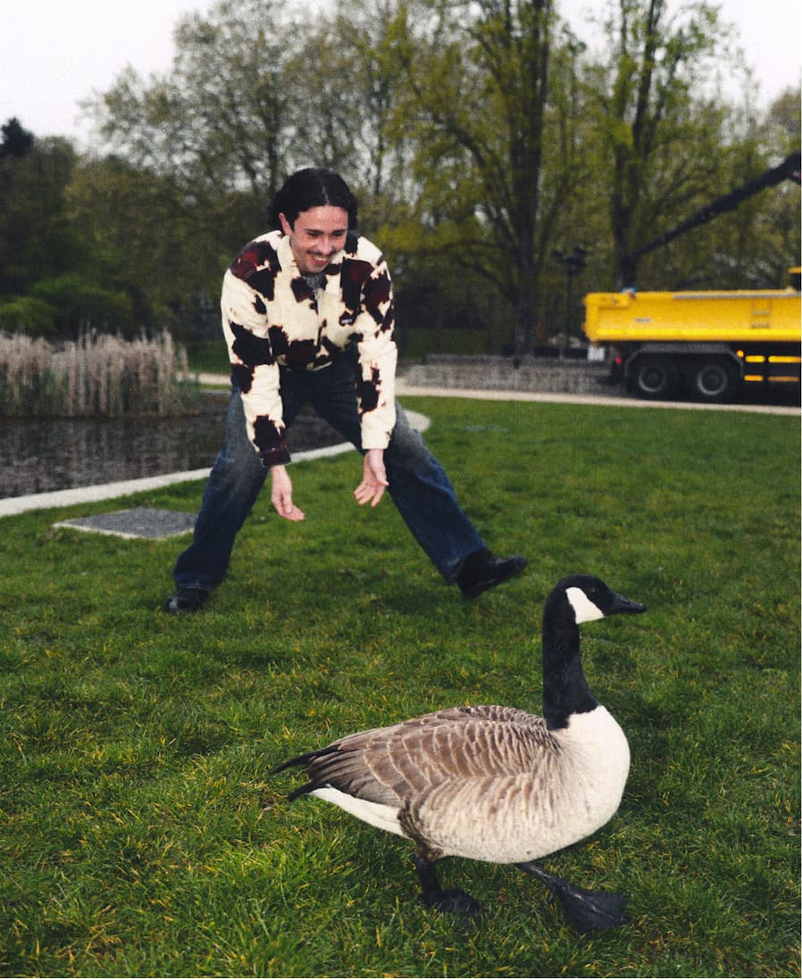 Men Model playing with a duck in the yard wearing Obey fall 2026 collection Jacket
