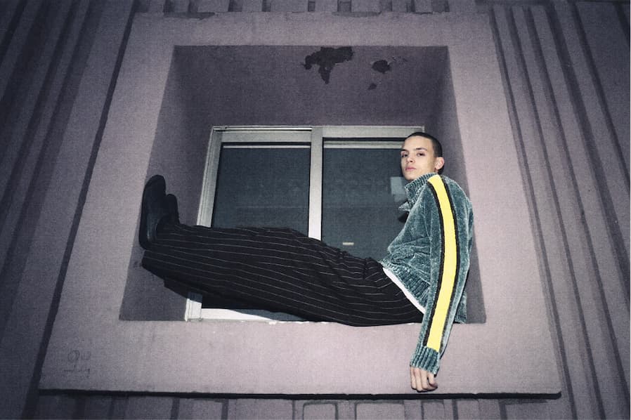 Men Model siting in a window frame wearing Obey fall 2026 collection