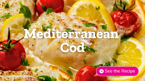 Mediterranean cod pictured with tomatoes, herbs, and lemon