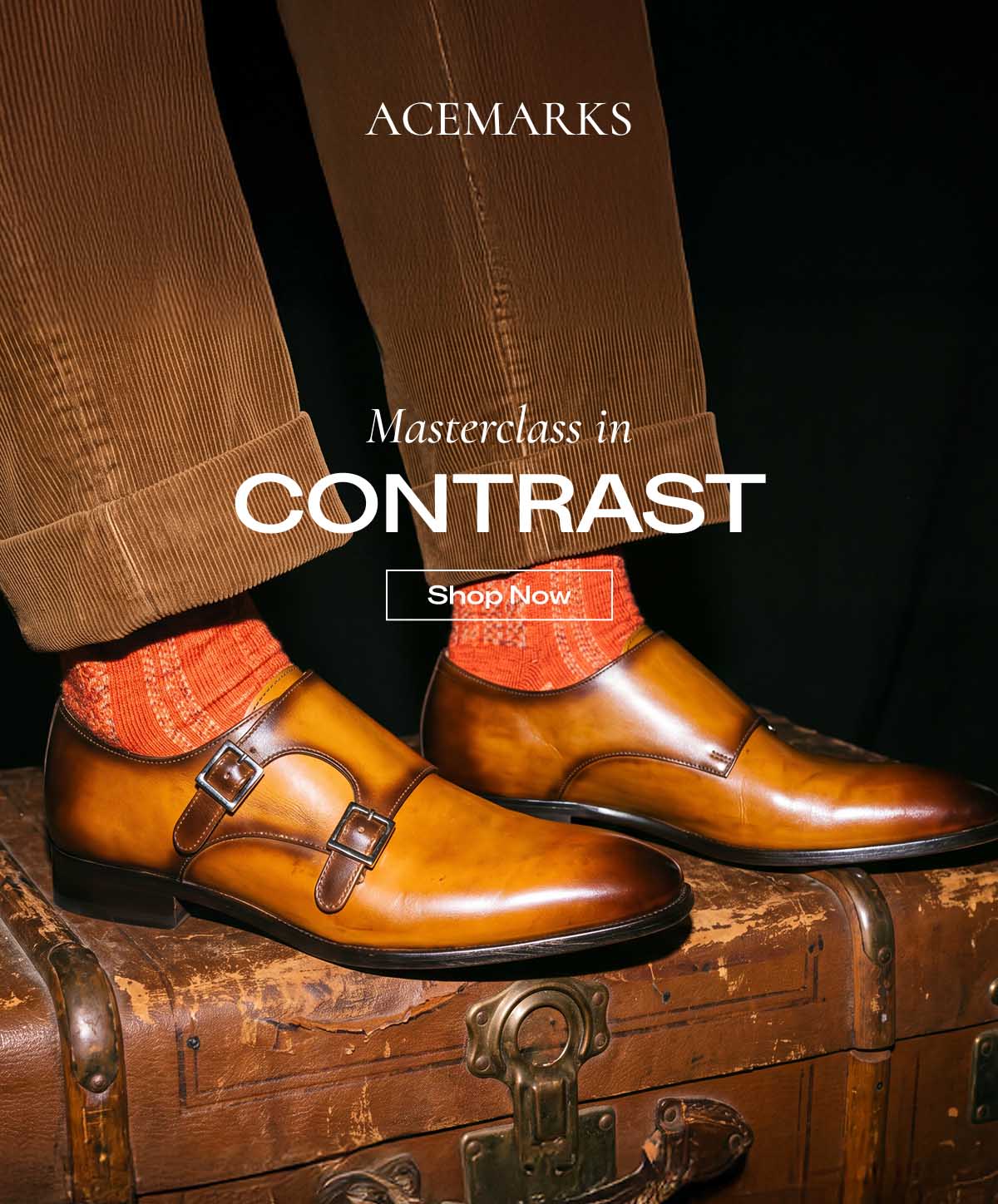 Here is the transcribed text from the uploaded image (Ace Marks "Masterclass in Contrast" marketing email, image_bcc817.png):  Hero Section ACE MARKS  (Image: Lower-body shot of a person sitting on a vintage leather trunk, wearing brown corduroy trousers, patterned orange socks, and hand-burnished tan/amber double monk strap dress shoes)
