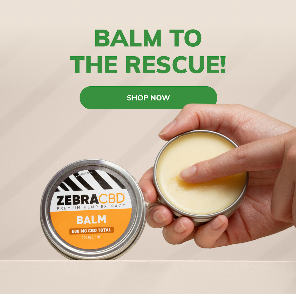 A hand holding an open tin of balm with finger dipping in. Text reads "BALM TO THE RESCUE!" with a green "Shop now" button.