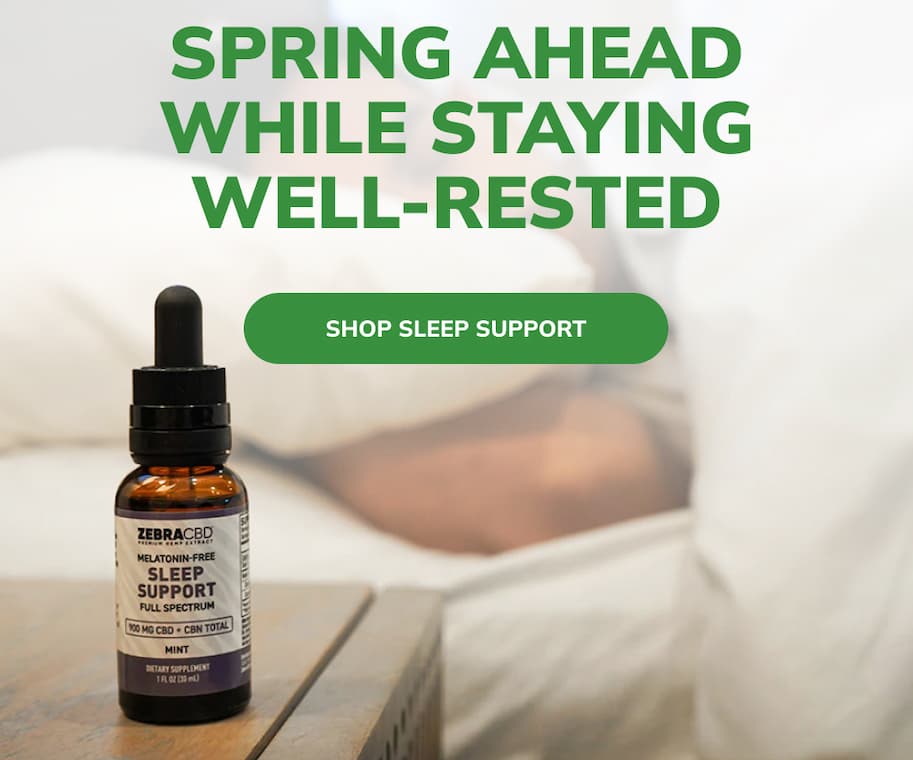 Bottle of CBD Sleep Support Full Spectrum Oil on a bedside table with the text "spring ahead while staying well-rested"