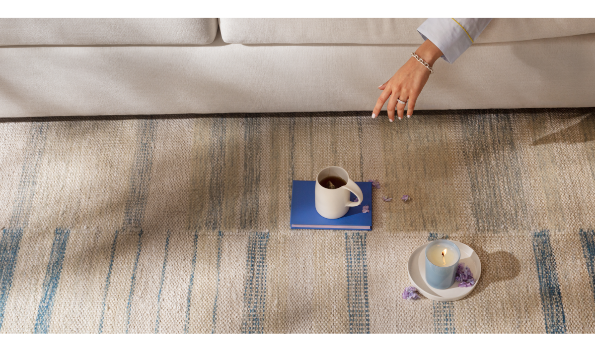 Flatweave rug with candle, coffee mug, and couch