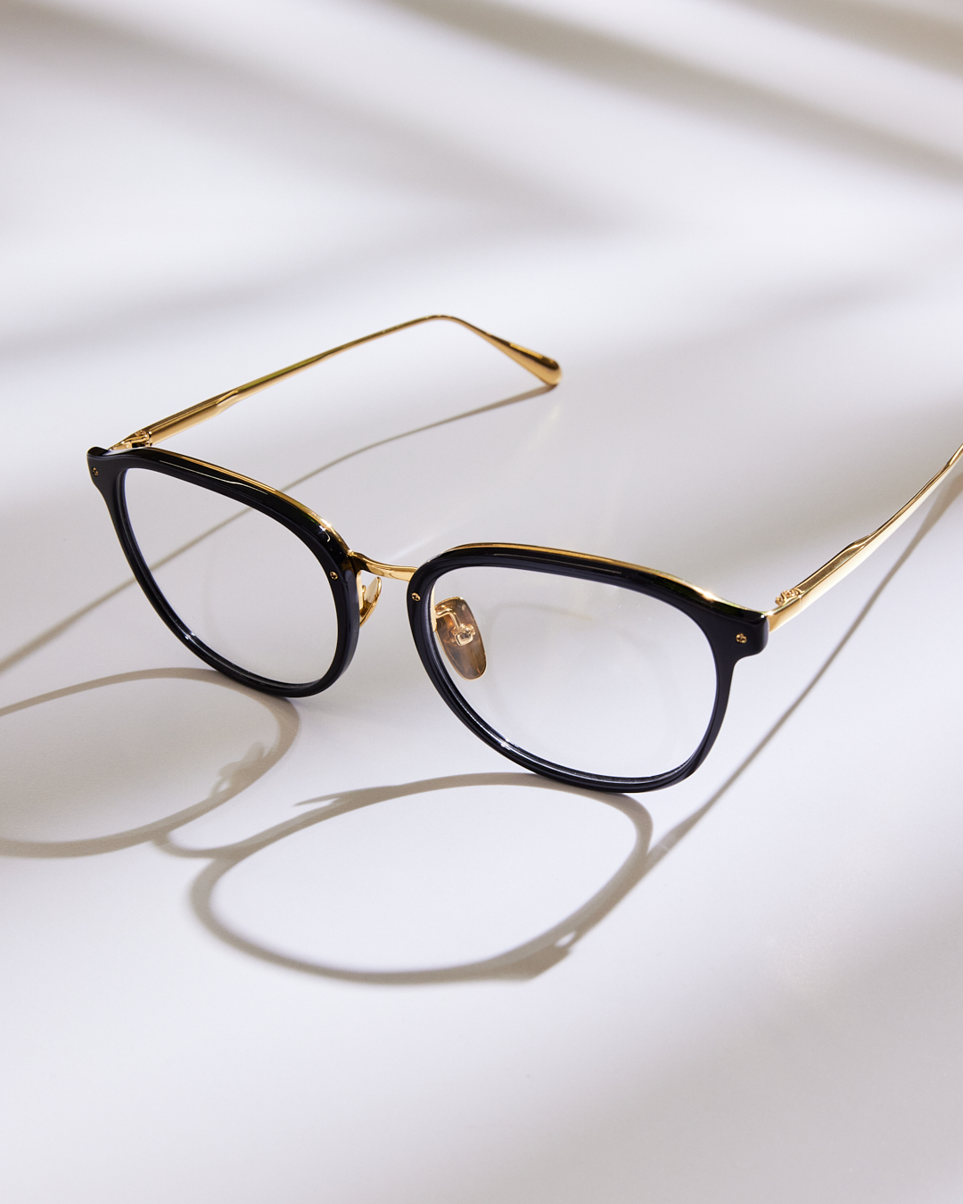 linda farrow glasses with gold arms and black framse