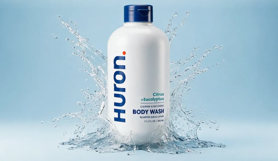 Huron Citrus + Eucalyptus Body Wash bottle with water splash, 11.3 fl oz.