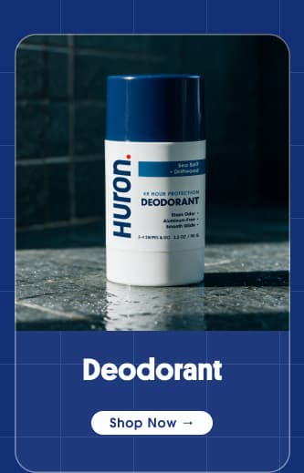 Huron Deodorant stick on wet stone shower ledge with "Shop Now" button.