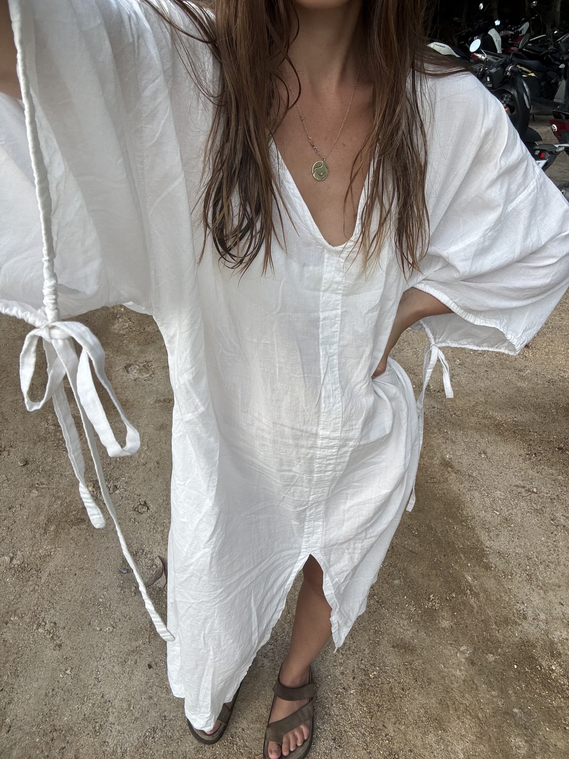 The Ibiza kaftan in white, worn over swimwear