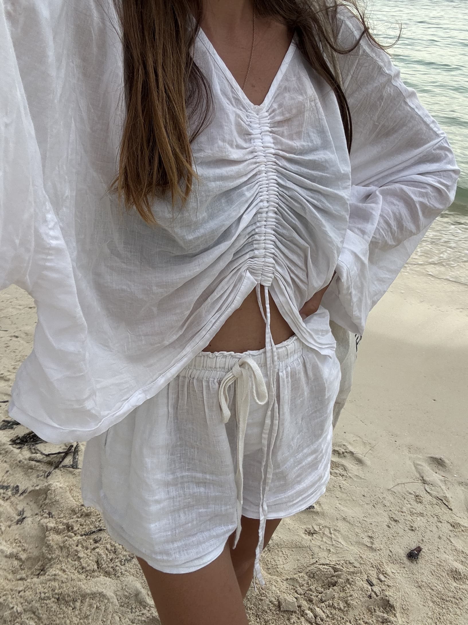 The Ling blouse in white styled with the Cooper shorts