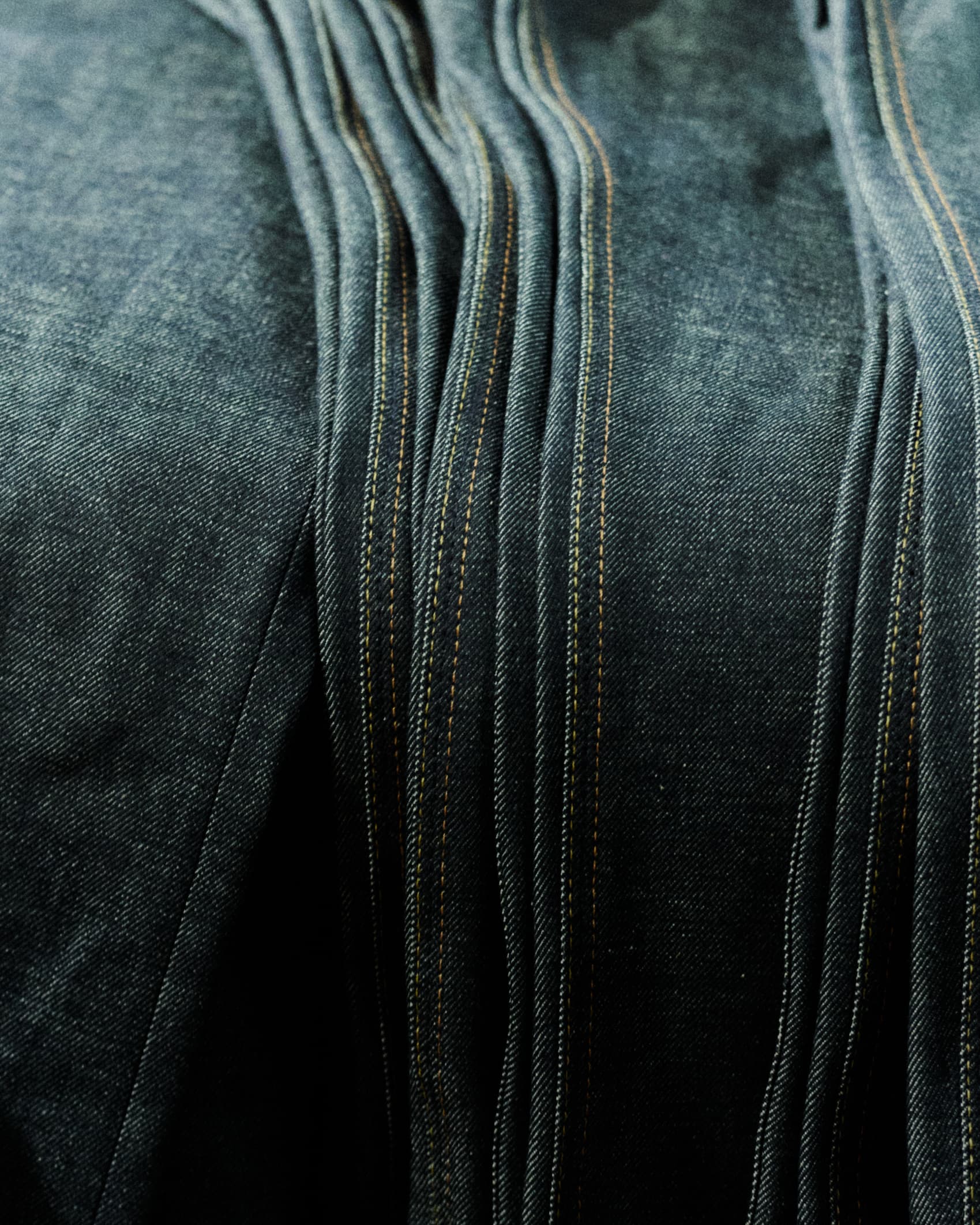 Close-up image of Hiut jeans stacked.