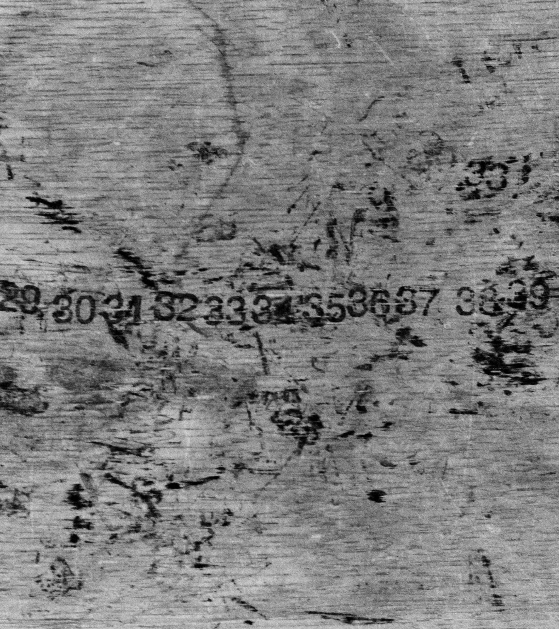 A black and white image of numbers in a line printed with ink.