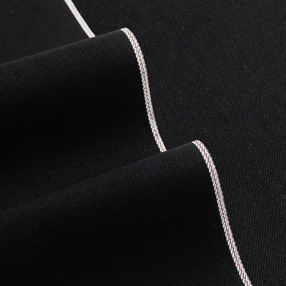 close up photo of black selvedge denim.