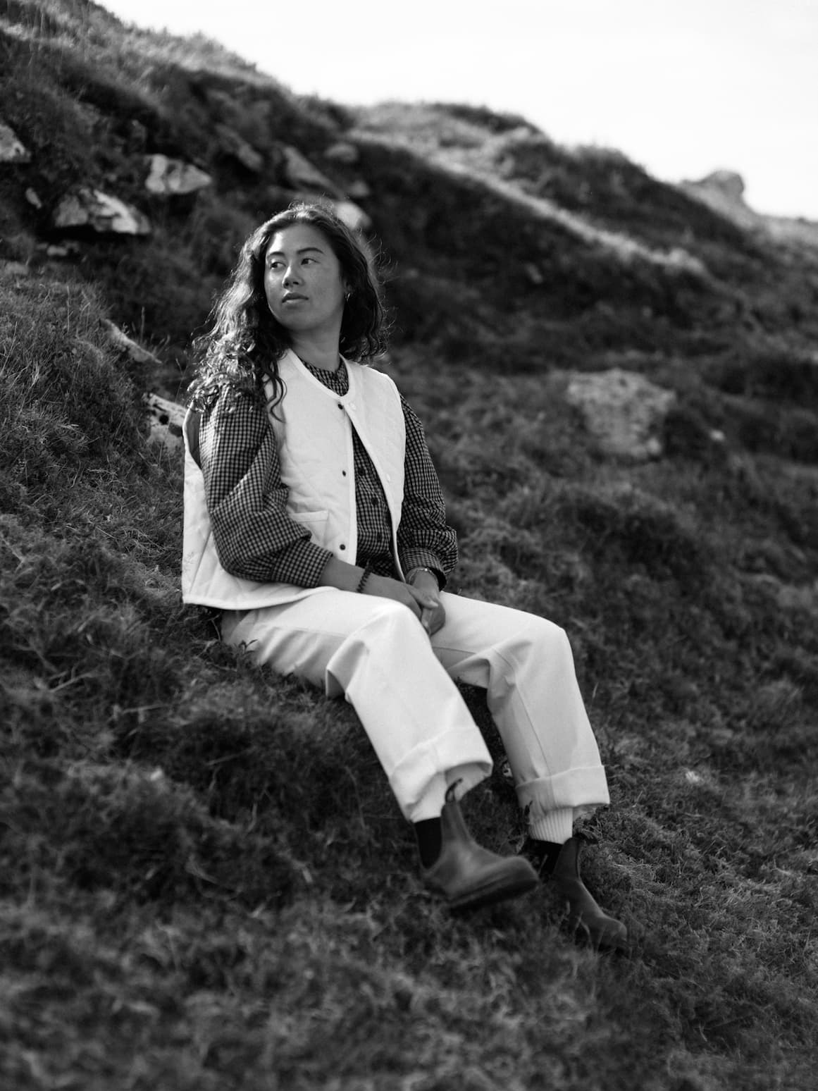 Young woman sitting in a field.
