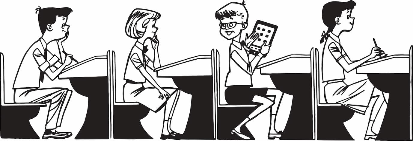 Four kids at desks with one holding a tablet