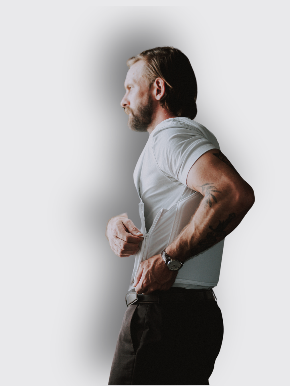 man zipping up side of white armor vest man zipping up side of white armor vest