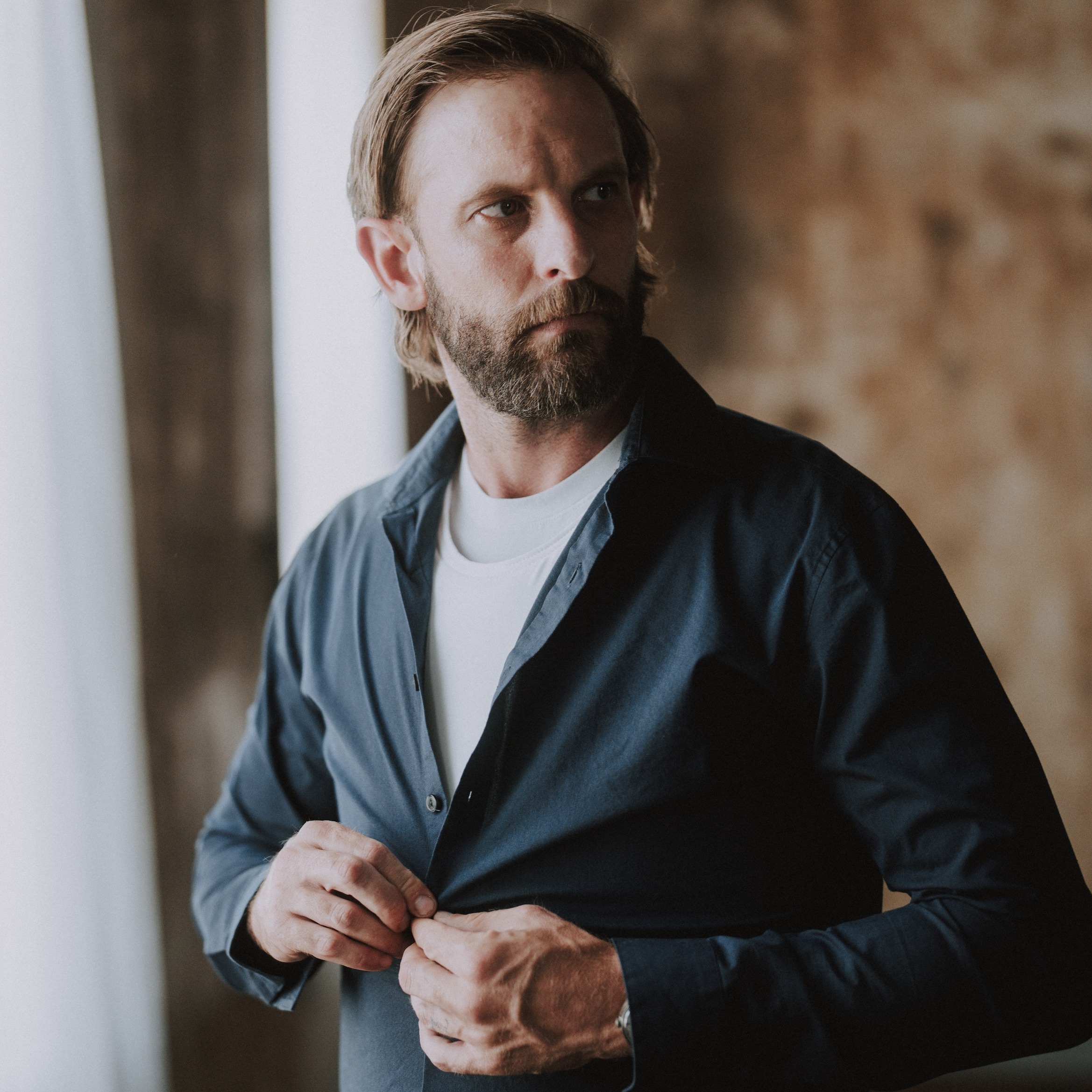 mean putting on blue button down over white armor vest