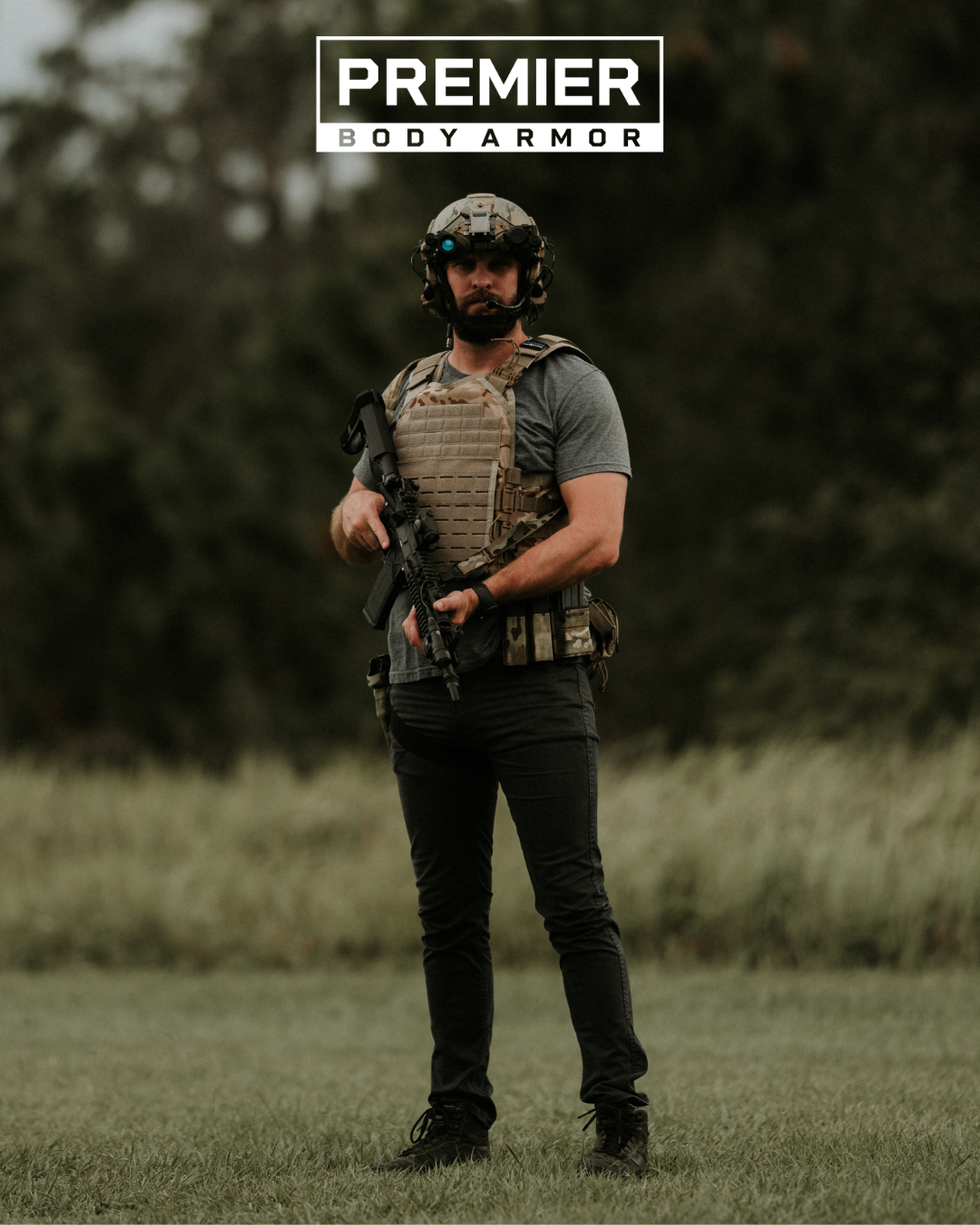 man in field wearing tactical gear including multicam plate carrier and ballistic helmet