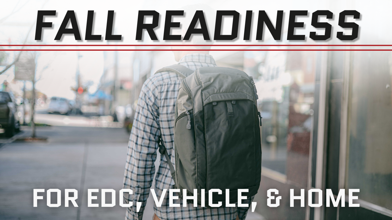 Man with backpack on a city sidewalk. EDC in fall layers