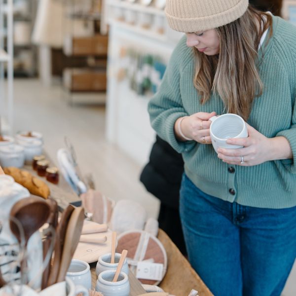 A Collector holding a freshly thrown mug at the store table in Woodstock, Vermont