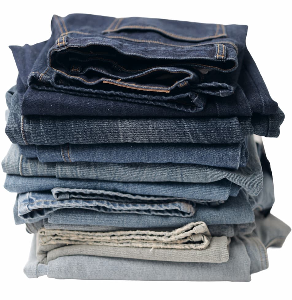A pile of all the demin pants folded from Obey fall collection