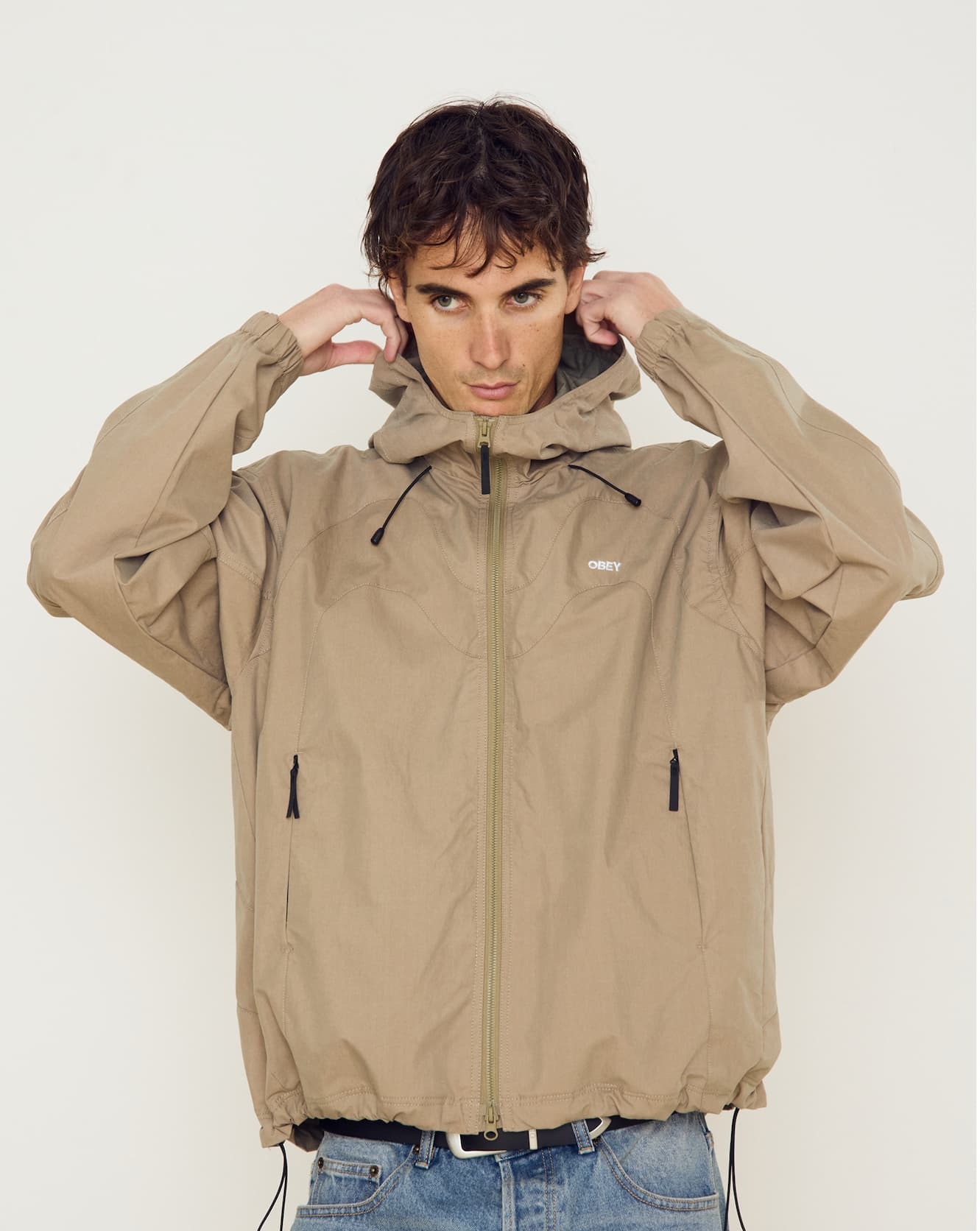 an image of a man in a jacket is holding his head