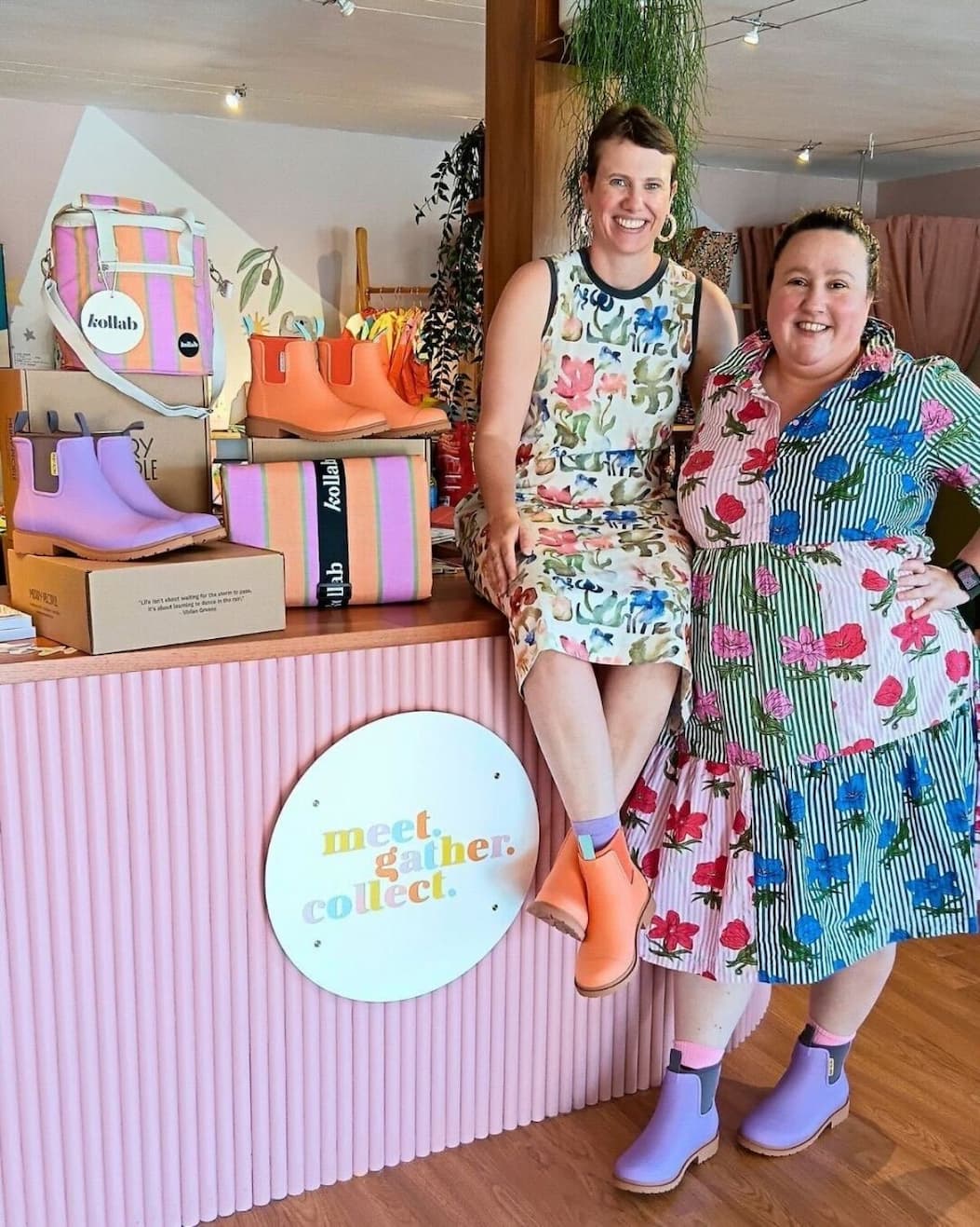 an image of two women standing next to a counter in boots