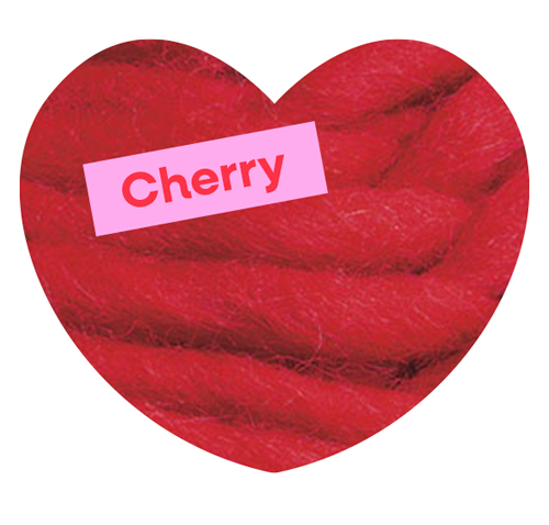 A close up shot of red yarn. Cherry