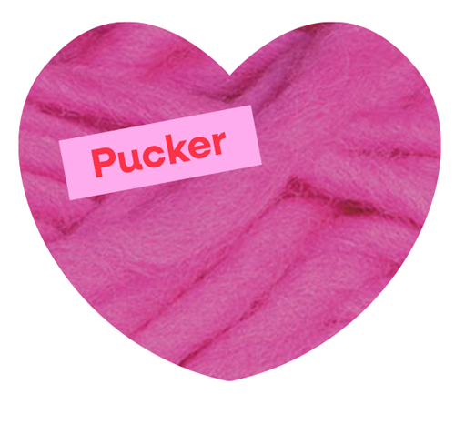 A close up shot of pink yarn. Pucker