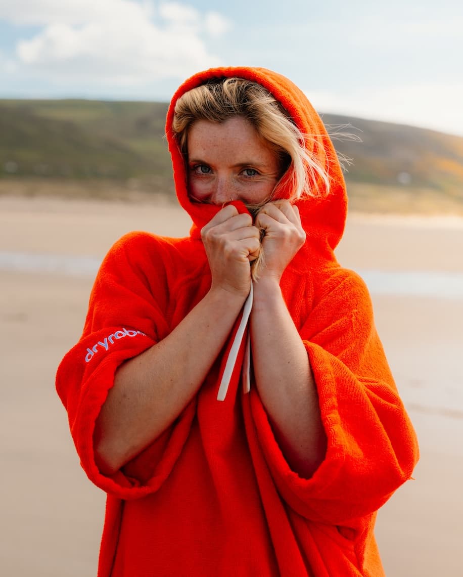 Woman on the beach wearing a towel robe