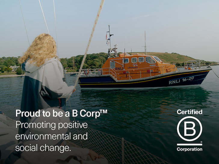 Woman on boat in Dryrobe® RNLI Nexus by lifeboat