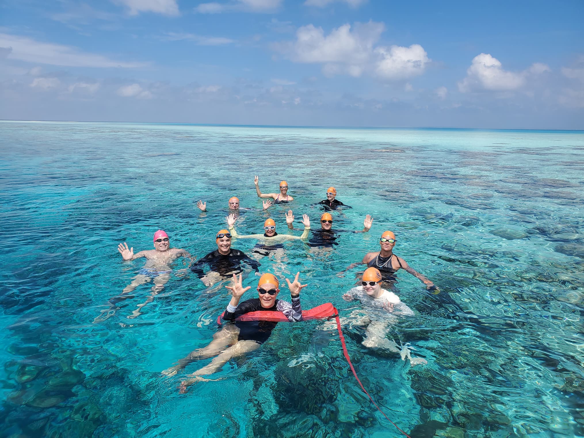 Group of swimmers in clear-blue waters