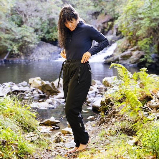 Woman wearing Dryrobe® Trousers with a wild pool in the background