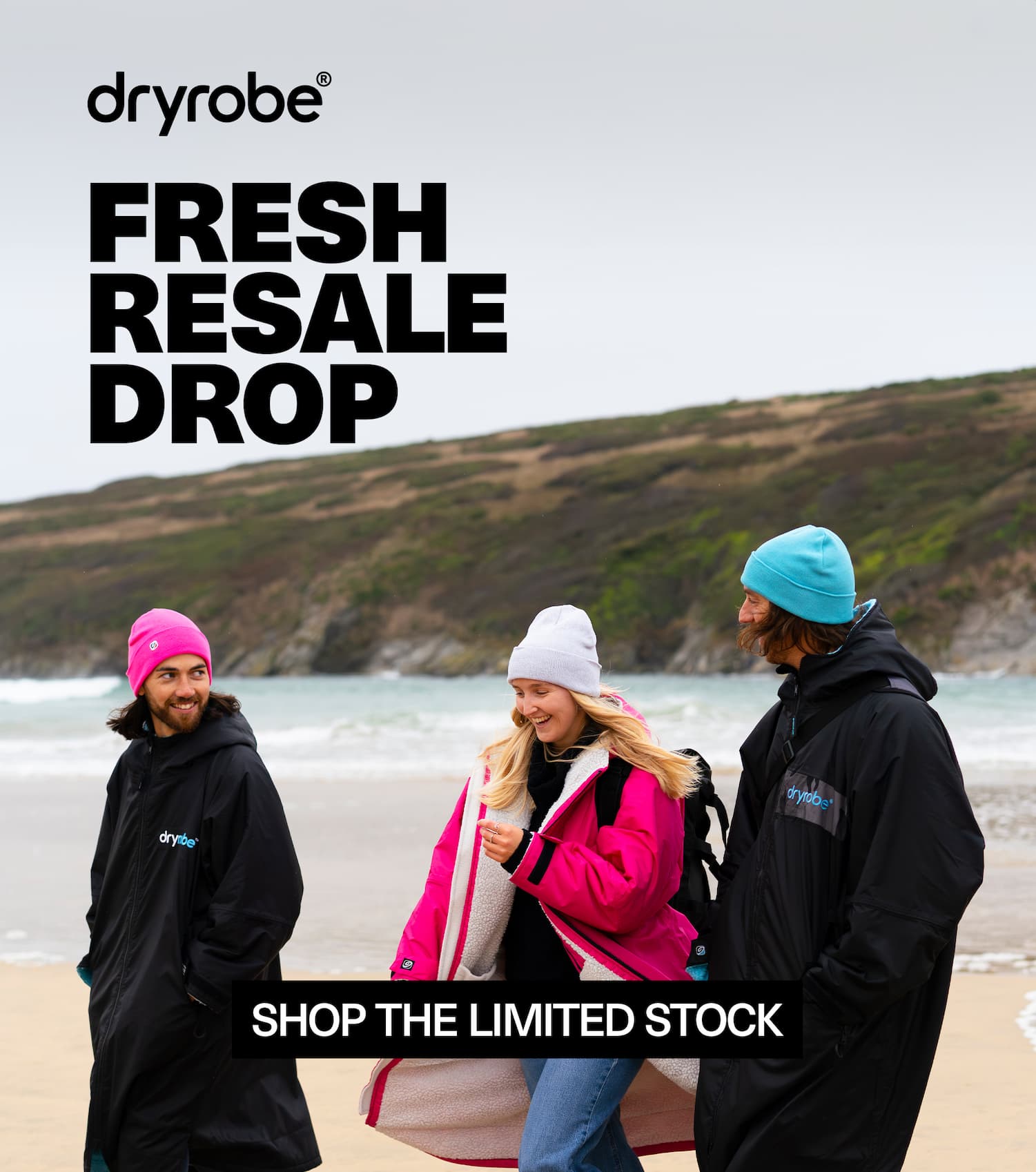 Three friends on a beach wearing Dryrobe® changing robes