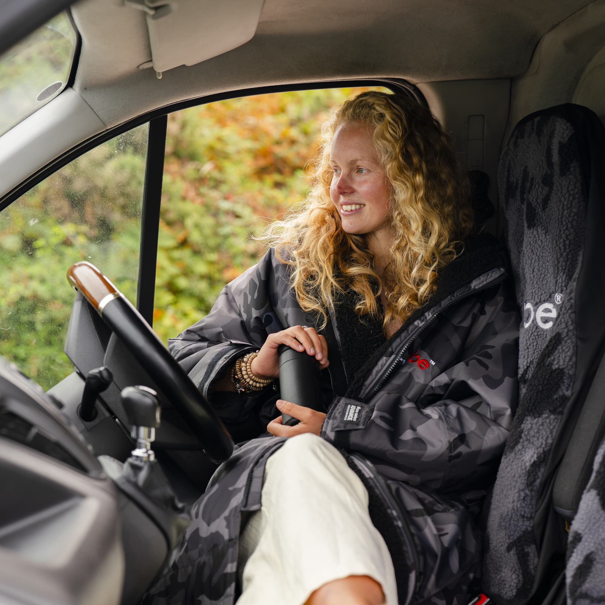 Woman sat in a Dryrobe company vehicle